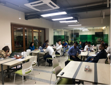 During the session about access to finance. Several people are seated in multiple tables and chairs.